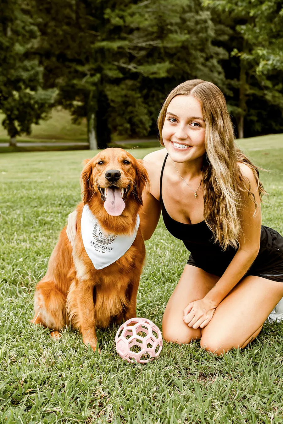Avery with a golden retriever wearing an Averyday bandana