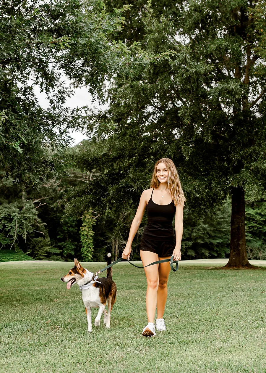 Avery walking the shepherd mix on a leash