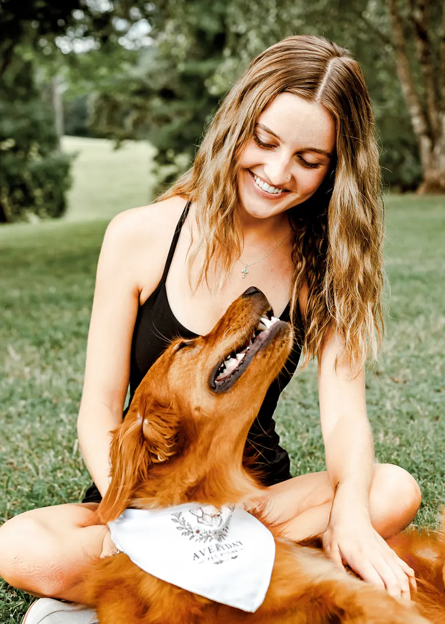 The golden retriever reaching up to kiss Avery