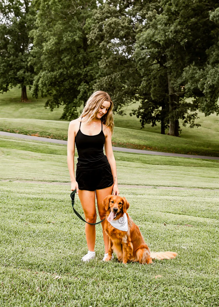 Avery standing with the golden sitting at heel