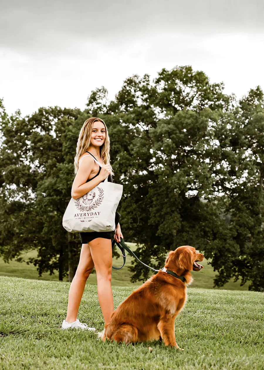 Avery with the Averyday tote and the golden sitting beside her